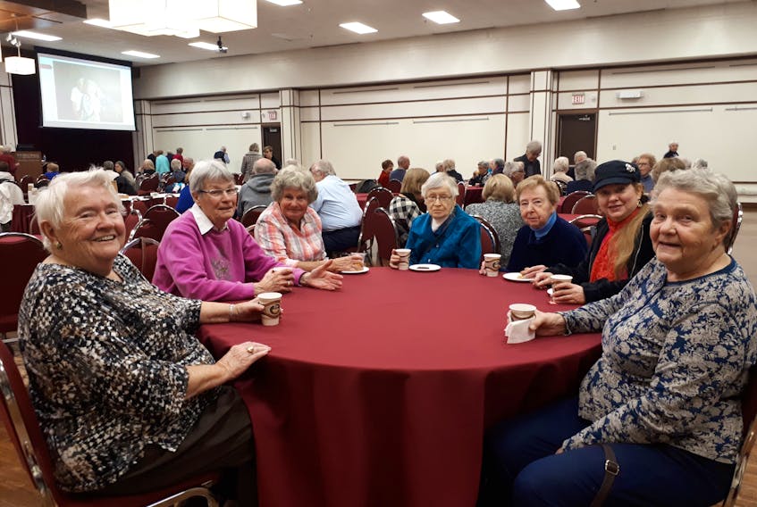 Seniors socialize during a coffee break at a 2018 Elder Learners talk.