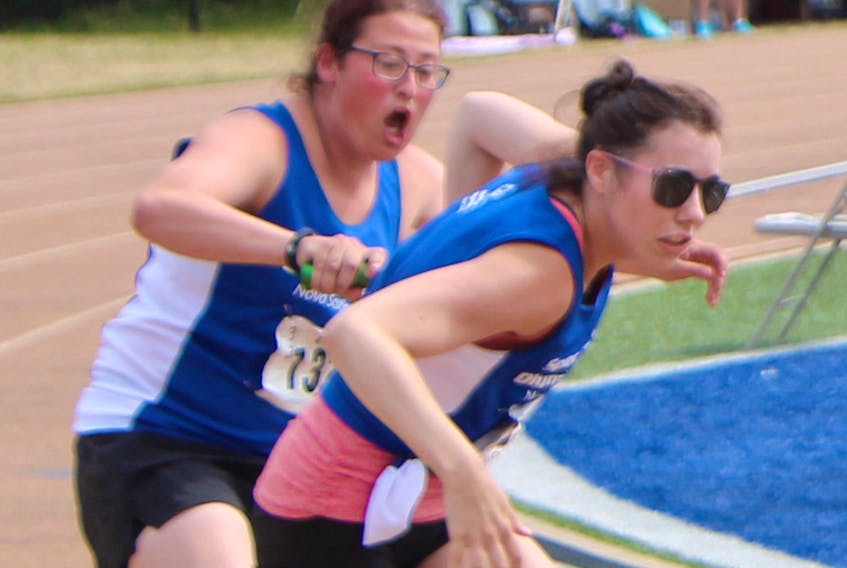 Kristina Richard of Antigonish and Joy MacLachlan of Halifax make the baton exchange for Team Nova Scotia during a 4X100m relay race Saturday afternoon on the final day at the Special Olympics Canada 2018 Summer Games in Antigonish. Corey LeBlanc