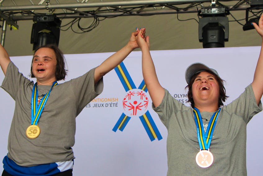 Team Nova Scotia athletics’ members Lisa Leuschner (gold) and Hannah Deon (bronze) soak up the applause while on the medal podium Saturday on the final day at the Special Olympics Canada 2018 Summer Games in Antigonish. Corey LeBlanc