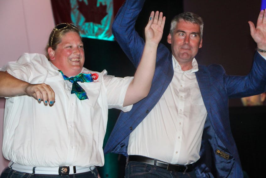 Nova Scotia Premier Stephen MacNeil joins Nova Scotia Special Olympics Summer Games athlete Stacey Saunders in dancing to the music of Antigonish rock band The Trews, near the conclusion of the Games' opening ceremony Tuesday (July 31) night, at the Keating Centre on the campus of St. F.X.