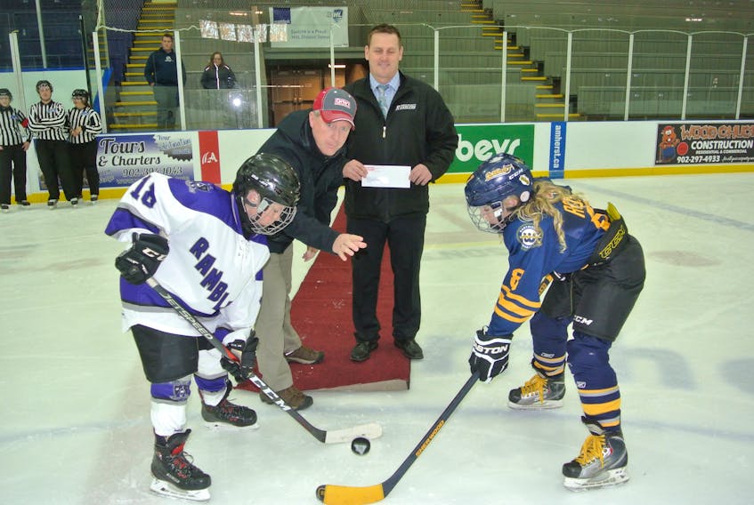 Carter’s Sports Cresting continues to be a strong supporter of the Bluenose Minor Hockey Tournament. Mark Carter of Carter’s Sports Cresting drops the puck between Cumberland County Amherst Fire Department Atom A Ramblers captain Jaxon Harrison and Dartmouth Whalers captain Cayd Ross while Cumberland County Minor Hockey Association president Jason Rhinas looks on. Moncton won the Atom A title while Yarmouth won the Bantam AA championship.