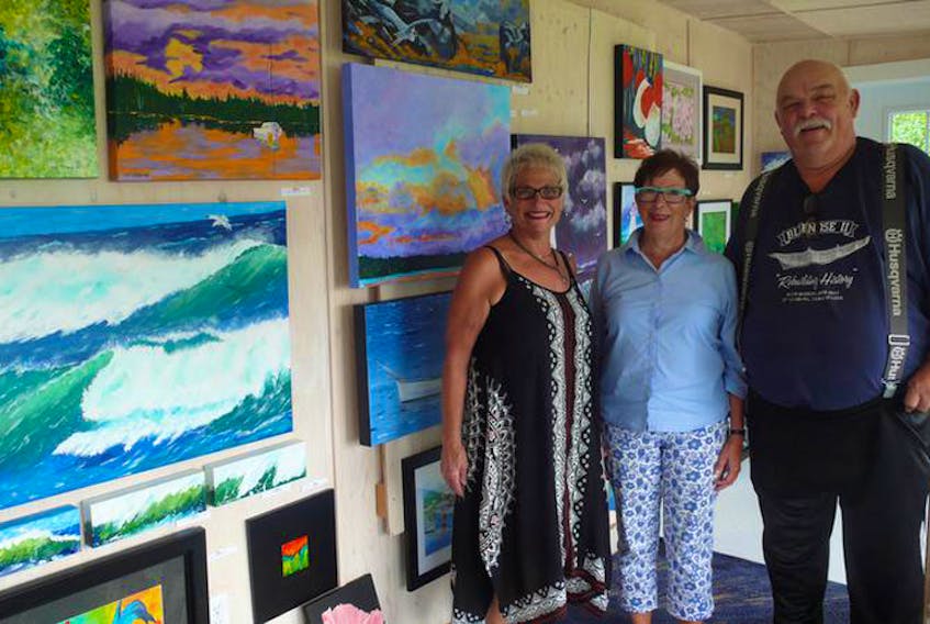 Painter Janet Clattenburg, art show organizer Victoria Fraser and crafter Laurie Clattenburg are shown in the Clattenburg’s Port Medway gallery, Chisel and Brush.