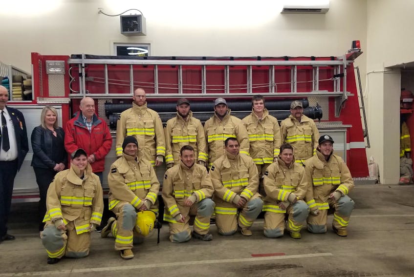 Eleven of the 13 Greenfield and District Fire Department members who are employed by Freeman Lumber don their new bunker gear, which was provided by mill owners Charlie and Richard Freeman. Together with other employee incentives, the donation is valued at more than $30,000. Standing, left to right: Fire Chief Moyal Conrad, Kim Masland, Charlie Freeman, Billy Freeman, Thomas McLean, Justin Delorme, Jesse Fleet and Nick Freeman. Kneeling, left to right: Nicole Karvelas, Tim Lohnes, Luke Freeman, Mark Nodding, Chris Wilson and Tyler Thorburne. Absent are Josh Rafuse and Steven Freeman.