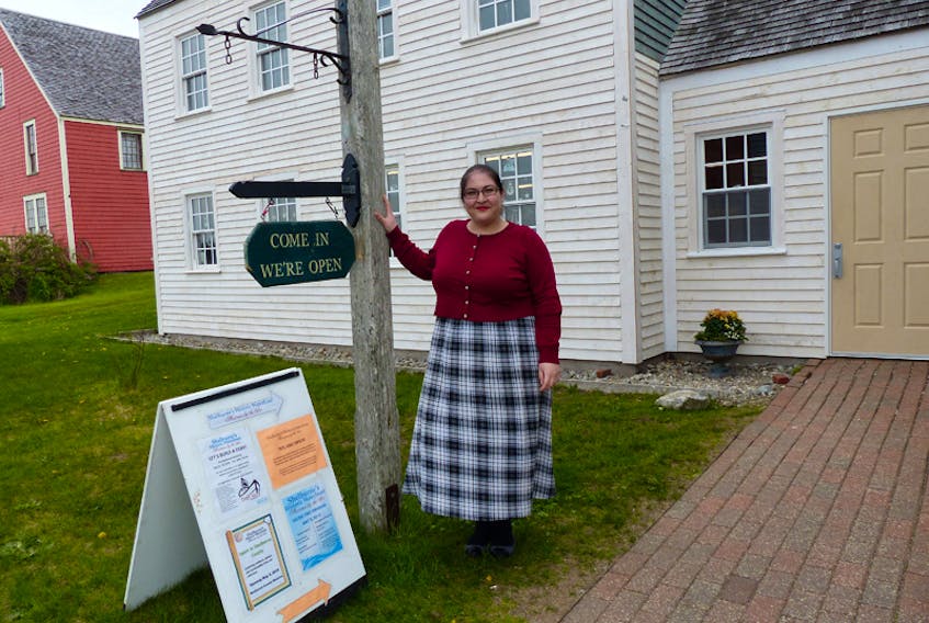 Cady Berardi is the new curator at the Shelburne County Museum. The museum’s newly refurbished exterior is visible behind her.