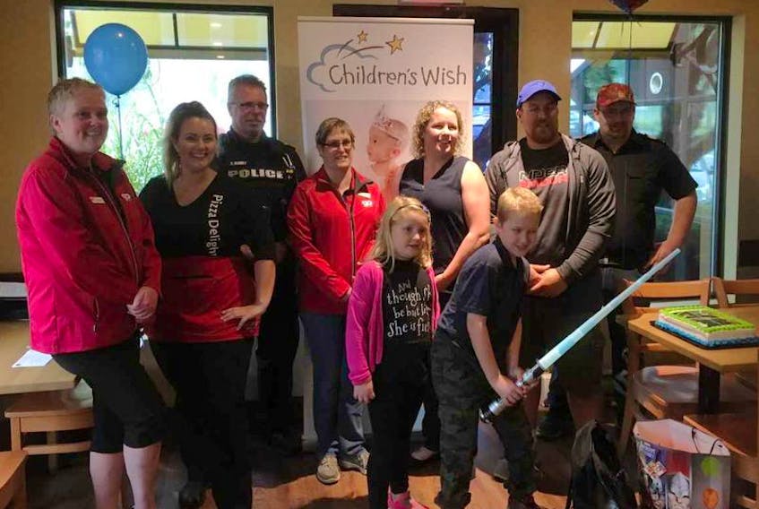 Staff from Wilson’s, Pizza Delight and members of the RCMP and Bridgewater Fire Department were on hand to help Ethan Trethewey (with light sabre) and his family to celebrate his wish being granted through the Children’s Wish Foundation, Nova Scotia Chapter, to recieve Jedi training. The presentation took place on Sept. 28, at thr Pizza Delight in Bridgewater.