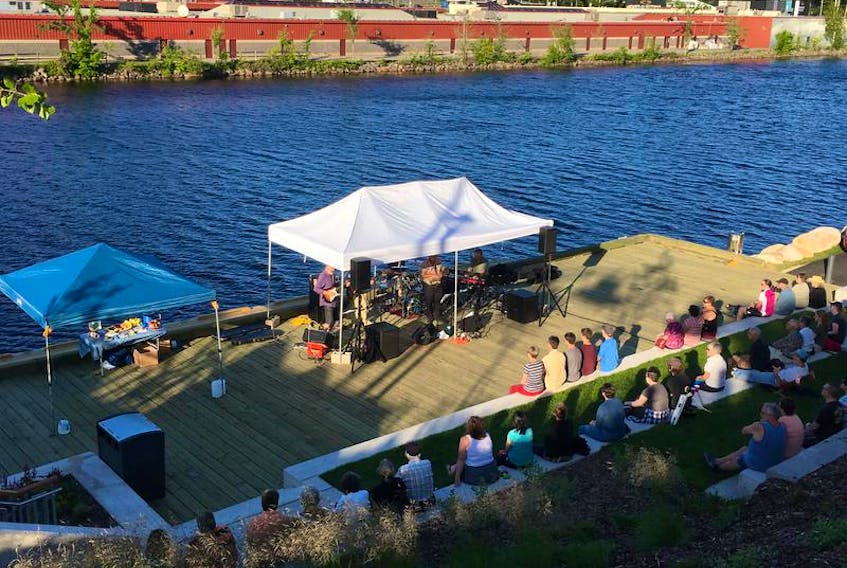 Musicians perform along the waterfront at last year’s Music Along the Riverbank.