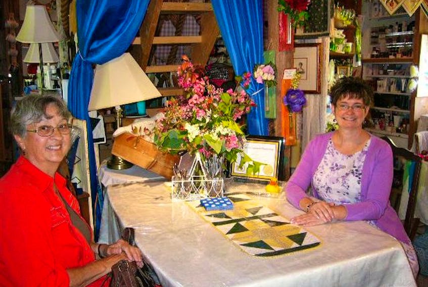 Crabapple Creek shop owner Melissa Eisnor (right) and customer Peggy Ernst take a moment to catch up at Crabapple Creek in Parkdale.