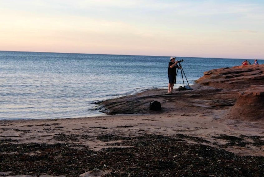Photographer Peter Zwicker prepares for a shot along the ocean. The ocean, said Zwicker, is his favourite subject to shoot because it is constantly changing and in motion. (Peter Zwicker)