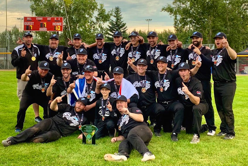 Members of the Galway Hitmen celebrate after winning the Canadian senior men's fastpitch championship in Grande Prarie, Alta., on Sunday. The defending champion Hitmen defeated the Sooke, B.C., Loggers 10-7 in the final, giving Newfoundland its seventh national crown in eight years. — Facebook/Galway Hitmen