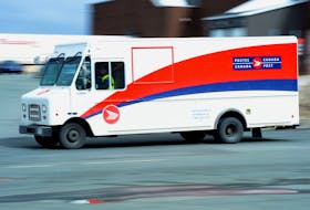 A Canada Post truck makes its way down Pippy Place near the main Kenmount postal station Tuesday. Mail delivery resumed Monday following a shutdown when an employee at the station tested positive for the coronavirus.