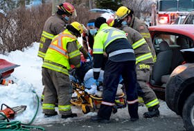 Firefighters used extrication tools to free the driver of a car involved in a two-vehicle collision Wednesday afternoon. Keith Gosse/The Telegram