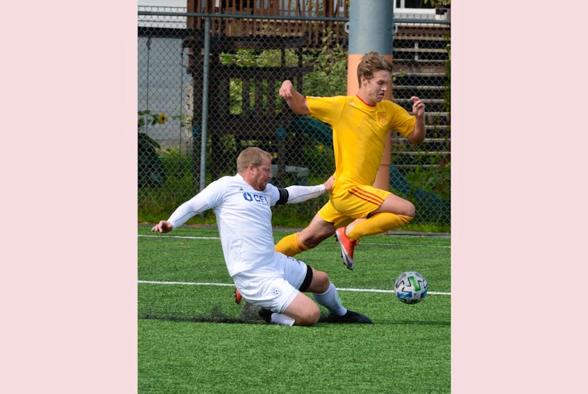 Jacob Grant (right) of Holy Cross and Marc Pittman of St. Lawrence fight for the ball during Challenge Cup soccer action at King George V field Sunday afternoon.