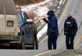 RCMP officers were examining a pickup on Route 10 on the southern shore highway Friday related to a suspicious death. Keith Gosse/The Telegram
