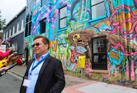 Mary Brown’s owner and CEO Greg Roberts speaks with reporters on Saturday at the company’s mural unveiling on Adelaide Street. –Juanita Mercer/The Telegram
