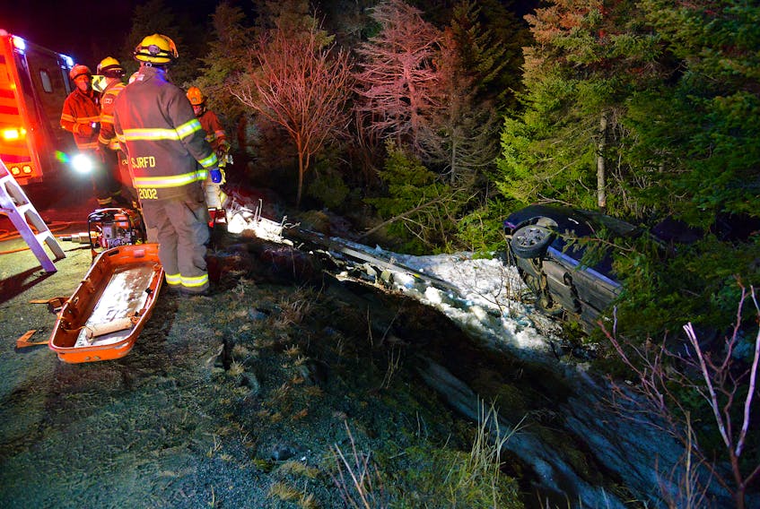One man was trapped in his overturned car until firefighters cut him from the vehicle early Friday morning. Keith Gosse/The Telegram