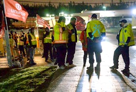 Police speak to union leadership before the picketers allowed trucks to leave the Weston lot. Keith Gosse/The Telegram