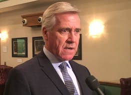 Premier Dwight Ball speaks to reporters Tuesday outside the House of Assembly.