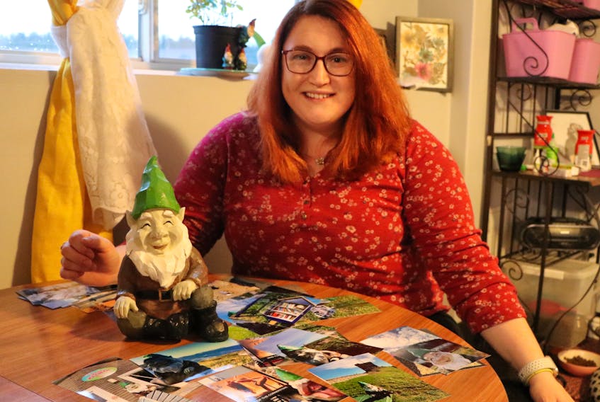 Foxtrap resident Lindsay Holloway with her returned gnome on Wednesday, and pictures of its travels left by culprits unknown. The gnome was stolen from her front lawn about two weeks ago, but was returned Tuesday evening along with photos.