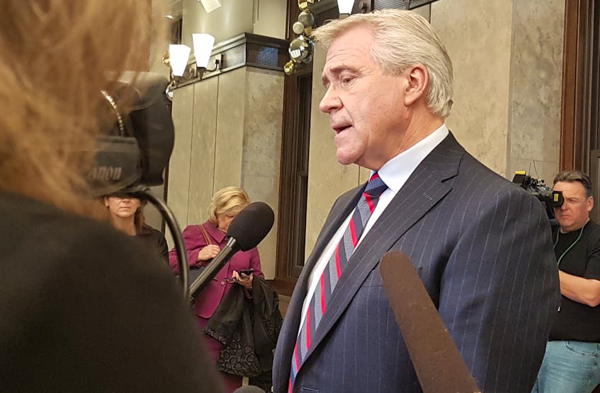 Premier Dwight Ball speaks to reporters Tuesday in Ottawa.
