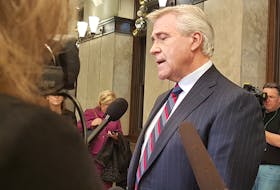 Premier Dwight Ball speaks to reporters Tuesday in Ottawa.
