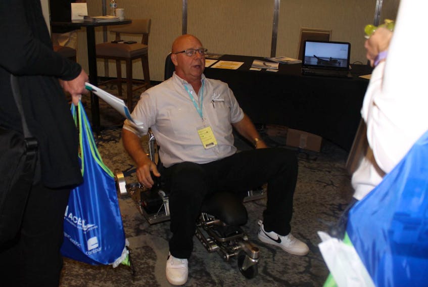 Human Hoist Canada national sales and marketing director Dan Lisicky tests the Human Hoist for the attendees of the Association of Canadian Ergonomists. An individual using the chair is able to go from a lying down position to upright easily with the product.