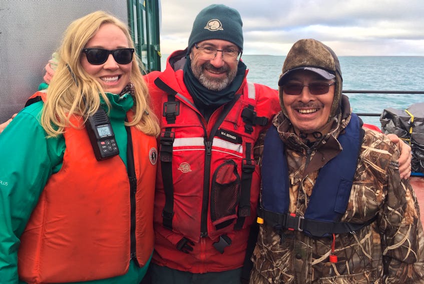 Latonia Hartery (left) with Parks Canada underwater archeologist Marc Bernier (centre) and Jacob Keanik of the Franklin Advisory Committee from Gjoa Haven, on a barge over the wreck site of the HMS Erebus in the Northwest Passage.