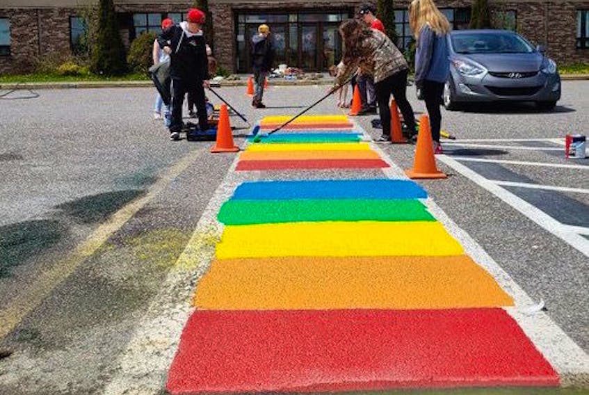 Students at Amalgamated Academy in Bay Roberts paint a rainbow crosswalk in front of the school last June.