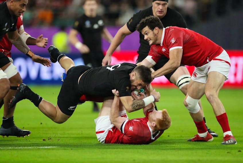 Ciaran Hearn (right), Peter Nelson (on the ground) and their Canadian teammates had a tough time stopping T.J. Perenara (left) and the New Zealand All-Blacks in Rugby World Cup play Wednesday in Oita, Japan. The defending champion All-Blacks blasted Canada 63-0 in a game played in muggy conditions. Hearn, who is from Conception Bay South, is one of two Newfoundlanders on the Canadian roster. Both he and Patrick Parfrey of St. John’s started Wednesday, with Hearn playing the entire 80 minutes and Parfrey coming out for a substitute 11 minutes into the second half. Canada (0-2) plays South Africa Tuesday and finishes up its preliminary-round schedule Oct. 13 versus Namibia. — Reuters