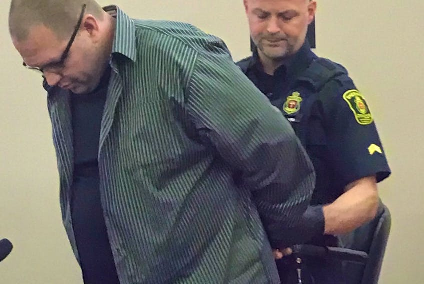 A sheriff places handcuffs on Peter Hoyles on Friday after he was sentenced to 18 months in prison for sexually assaulting a woman at a Paradise ice rink last February, and for breaching parole conditions.