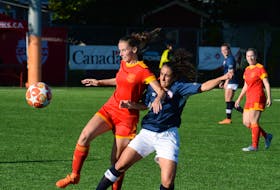 Jane Pope (left) of Holy Cross Avalon Ford moves the ball ahead of Suekiana Choucair of Edmonton Northwest United during their game on Wednesday, the opening day of the Toyota national senior men’s and women’s soccer championships in metro St. John’s. The Alberta team defeated Holy Cross, the Newfoundland and Labrador champion, 3-1 at King George V Park. — Joe Gibbons/The Telegram