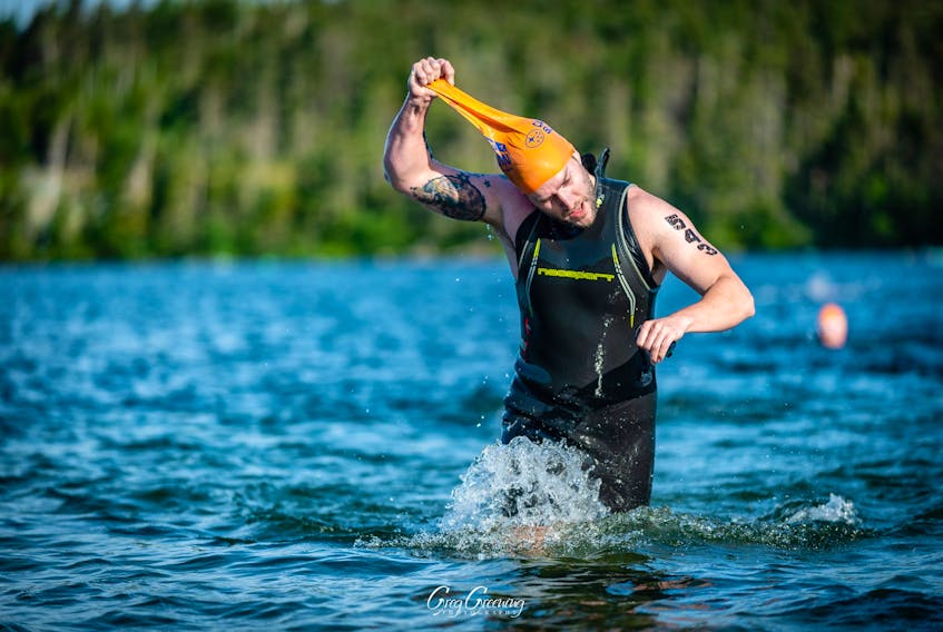 Gerald Sharpe struggles to get his swim cap off after completing the first discipline — the 750 metre swim — of the St. John’s Triathlon’s sprint Sunday. — Greg Greening Photography