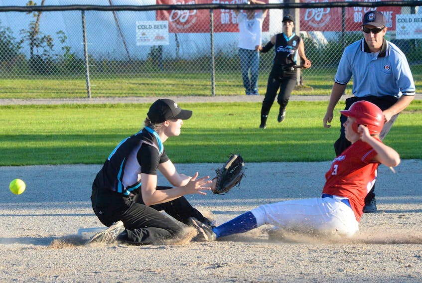 Katie Cameron of the Carnduff Southeast Steelers from Saskatchewan slides safely into second base after Galway shortstop Dayle Prowse was unable to come up with the ball during national softball championship action at Lions Park Wednesday night.