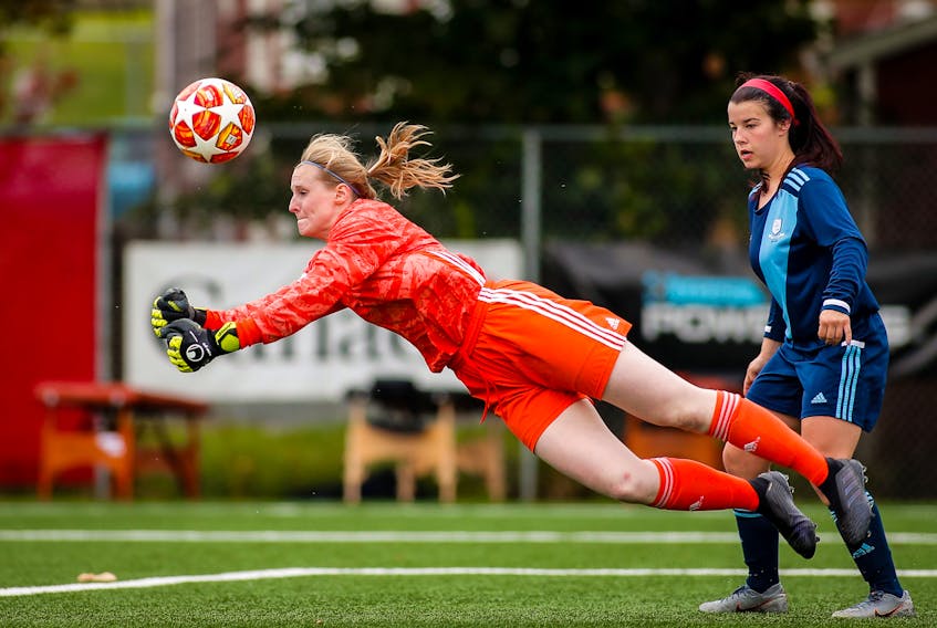 Feildians goalkeeper Sydney Walsh punches out the ball as teammate Chantel Armstrong looks on during the bronze-medal game of the Toyota Jubilee Trophy national women’s soccer championship Sunday at King George V Park in St. John’s. Feildians lost 1-0 on a late goal. Walsh allowed four goals in four games in the tournament. — NLSA photo/Trevor Wragg