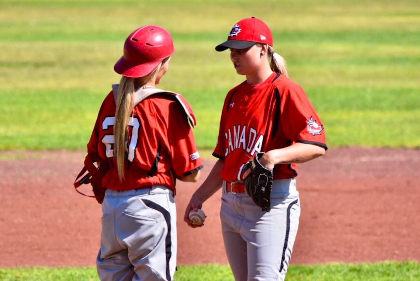 Newfoundland native and Team Canada pitcher Heather Healey (right) has a mound meeting with catcher Katlyn Ross during a game against Cuba Tuesday at the COPABE women’s baseball World Cup qualifier in Aguaslalintes, Mexico. — Twitter/Baseball Canada