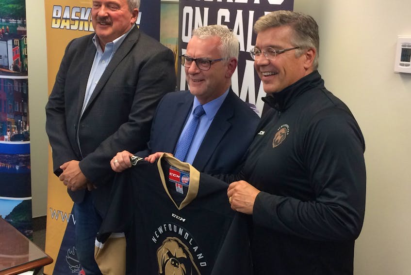 Newfoundland Growlers owner Dean MacDonald, right, presented Mayor Danny Breen with a Growlers jersey as Coun. Sandy Hickman, the St. John’s Sports and Entertainment board chairman, looked on following a news conference Wednesday in the mayor’s office to announce a 10-year agreement to lease Mile One Centre was agreed to in principle.