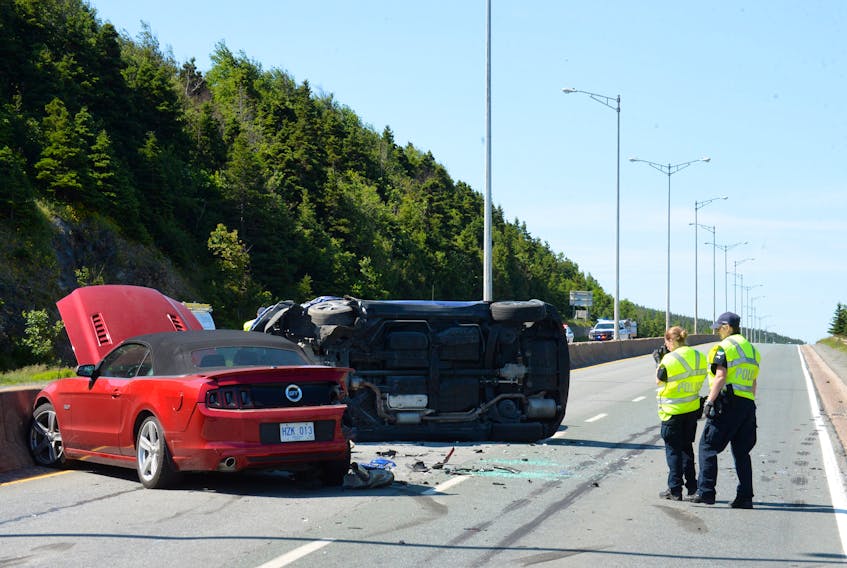 The Royal Newfoundland Constabulary (RNC) accident investigation team take photos of the multi-vehicle crash on Pitts Memorial from Friday morning. JOE GIBBONS/THE TELEGRAM