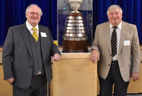 Alumni Ray Halley (left) and Harry Hamlyn pose with the Boyle Trophy during a reunion at St. Bonaventure’s College in St. John’s earlier this week. The Boyle Trophy was awarded to the St. John’s senior hockey champions from 1904 to 1971, with St. Bon’s claiming it 27 times, far more than any other team. That included a 16-year run that began 75 years ago, in 1944. Hamlyn was part of the Blue and Gold’s entry that took the trophy in 1959, while Halley won the Boyle Trophy as a player with the 1965 Memorial University side. — Submitted photo/Krista Cardwell