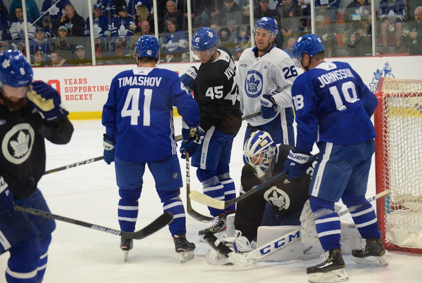 Toronto Maple Leafs netminder Michael Hutchinson pounces on a loose puck as teammates Dmytro Timashov (41), Teemu Kivihalmie (45), Nick Shore (26) and Andreas Johnsson (18) look on during a scrimmage Friday morning at the Paradise Double Ice Complex on the first day of the Leafs’ training camp.