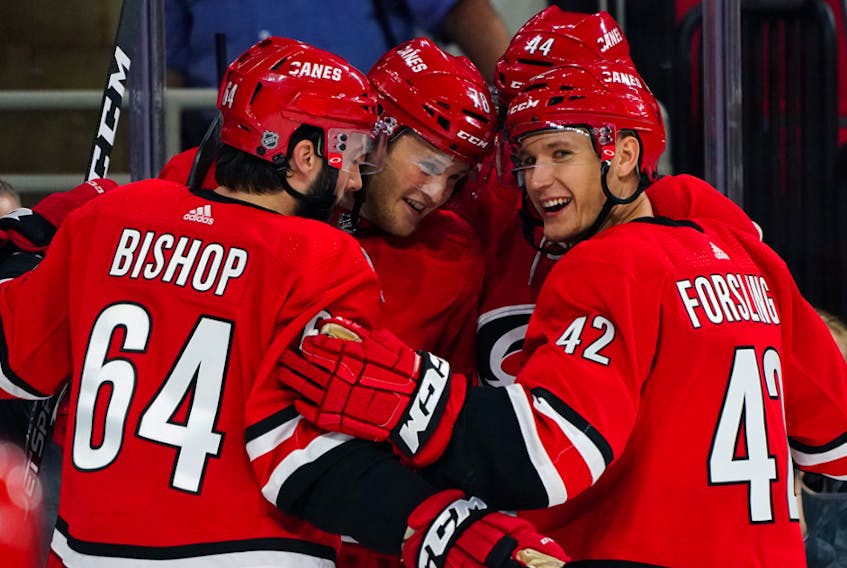 Clark Bishop of St. John’s celebrates his goal with teammates Wednesday in the Carolina Hurricanes’ 2-0 NHL exhibition win over the Tampa Bay Lightning. After appearing in 20 NHL games last season, Bishop hopes to land full-time NHL employment this year. — Carolina Hurricanes photo
