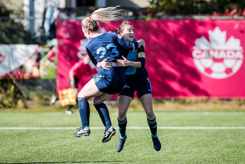 In this photo from Wednesday, Makayla Pearl (23) of Feildians and team captain Stacey Hanlon celebrate Hanlon’s game-tying goal against Scarborough, Ont., at the Jubilee Trophy Canadian women’s soccer championship at King George V Park in St. John’s. Feildians, one of two Newfoundland representatives in the national tourney, hope for more such celebrations today when they play their final preliminary-round game against Alberta’s Edmonton Northwest United at the Rainbow Gully Field in Portugal Cove-St. Philip’s. A win in that noon-time contest would guarantee Feildians a place in Sunday’s national championship final. — Trevor Wragg photo/via NLSA