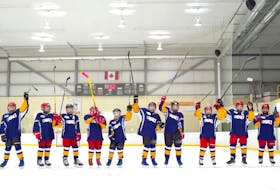 In this screenshot taken from the video that accompanies their entry, the Mount Pearl City Tire Blues raise their sticks as they campaign to raise awareness about the Kids Help Phone, the cause they are supporting as a regional finalist for the Chevrolet Good Deeds Cup. — https://gooddeedscup.chevrolet.ca