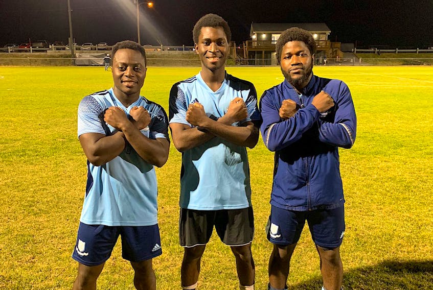 Feildians players Fomba Fambulleh, Felly Elonda and Emmanuel Dolo are shown after a recent win by the Double Blues in Johnson Insurance Challenge Cup play. The three are among the top four scorers for the Double Blues, with Dolo leading the way with seven tallies. That includes a hat trick Wednesday night in a 5-0 win over That Pro Look Strikers. Feildians have won all four of their decisions so far in September, all by shutout. — Feildian Athletics Association/Twitter