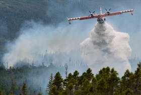 A waterbomber drops its load on a three-hectare brushfire burning Thursday afternoon near Fermuse on the Southern Shore. – Keith Gosse/The telegram