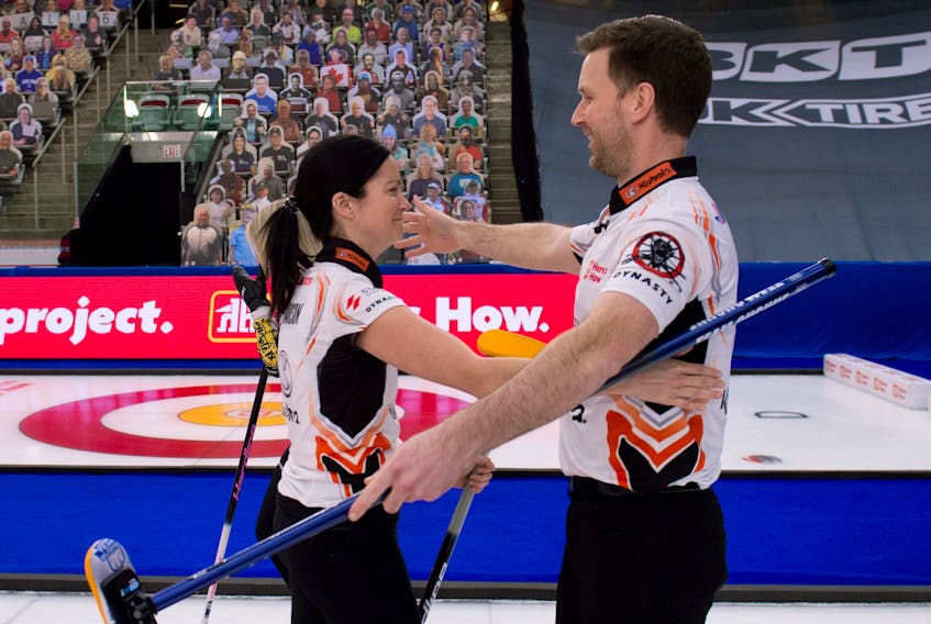 Kerri Einarson and Brad Gushue hug after winning the 2021 Home Hardware Canadian Mixed Doubles Championship Thursday night in Calgary.