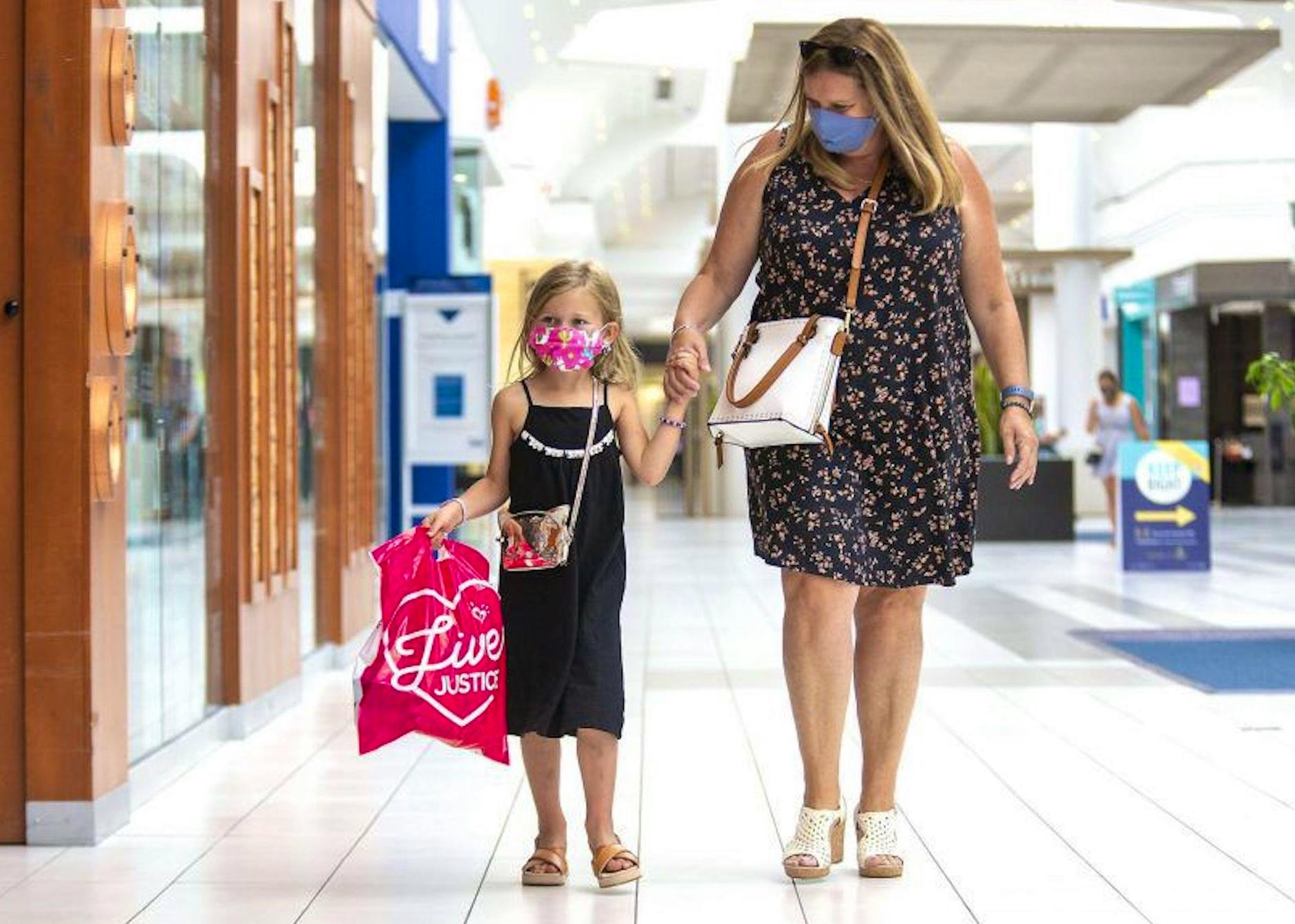 In this file photo from earlier this month, a woman and her daughter wear facemasks as they stroll through in a London, Ont., shopping mall. Beginning next Monday, Newfoundland and Labrador will join many other jurisdictions across Canada in making non-medical facemasks mandatory in public spaces.