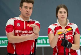 Newfoundland and Labrador champions Greg Smith and Mckenzie Mitchell discuss their next shot during a game at the Canadian mixed doubles championships in Calgary.