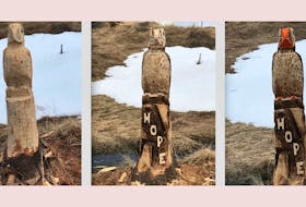 Progress is made on a carving of a puffin, emblazoned with the word “Hope,” earlier this month along a trail near Renews. — Contributed