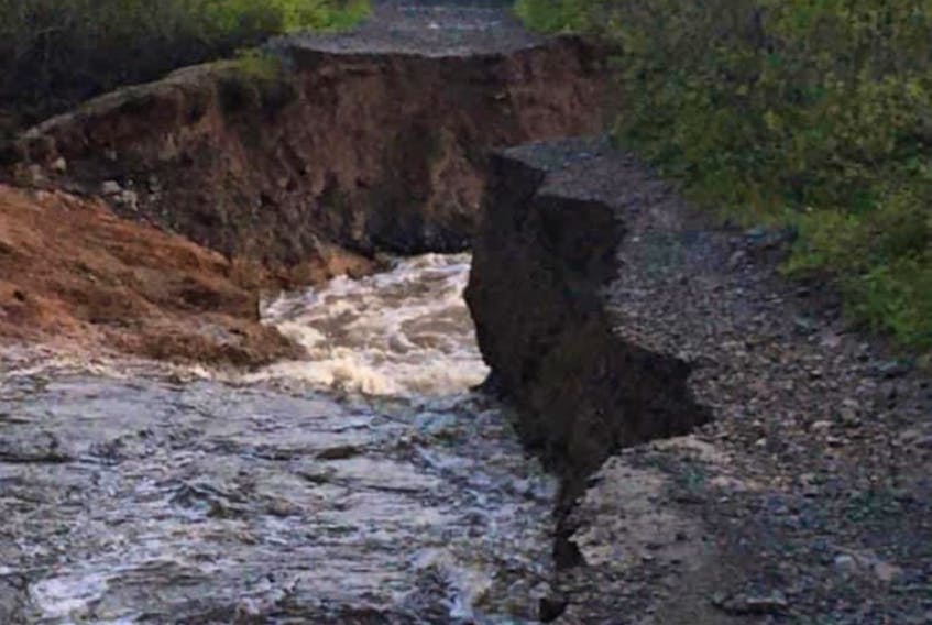A torrent of water is rushing through a washout on the TrailWay in the Whitbourne area. — Contributed/RCMP