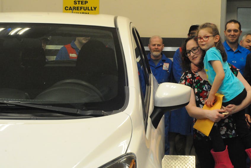 Above, Katherine Costello and daughter Maggie admire their new set of wheels. They received a free car courtesy of Collision Clinic in St. John's Wednesday – which also happened to be Maggie's seventh birthday.