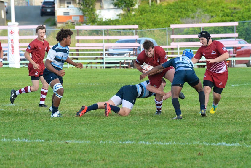 Brandon Bennell of the Ontario Blues tackles Hunter Ryan of the Atlantic Rock during their round-robin game at the Canadian under-19 men’s rugby championship at the Swilers Complex in St. John’s Thursday night. Also in on the play are Haeden Moher (14)  of the Blues and David Mallard (right) of the Rock. At the far left is Alex Wiscombe of the Atlantic side and the Blues’ Brayden Gray.